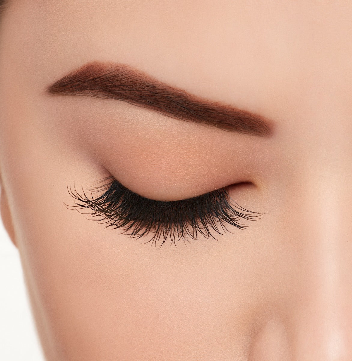 A woman with close eye wearing Ardell Active Lash Soak It Up  lashes