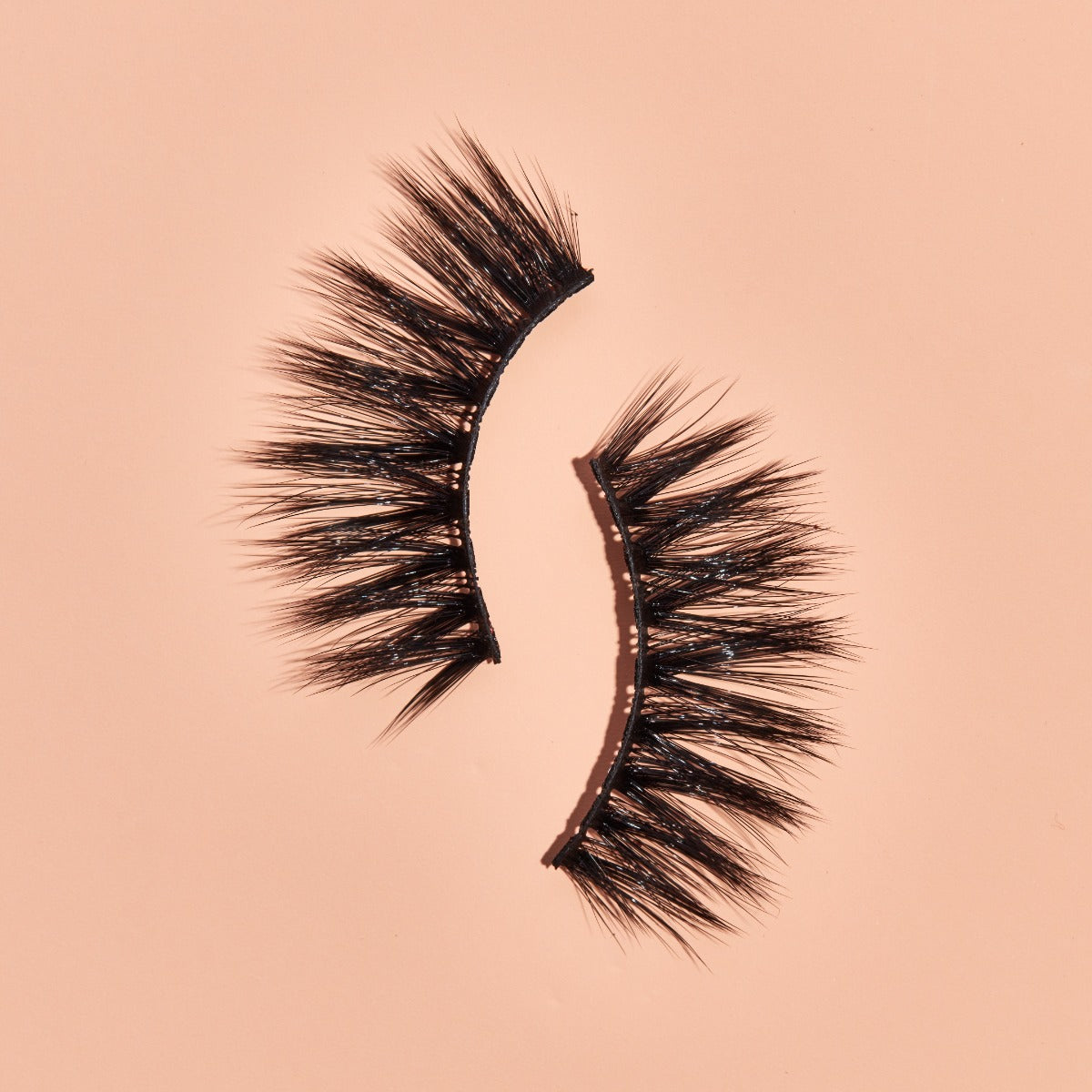 1 pair of lashes on a pink background 
