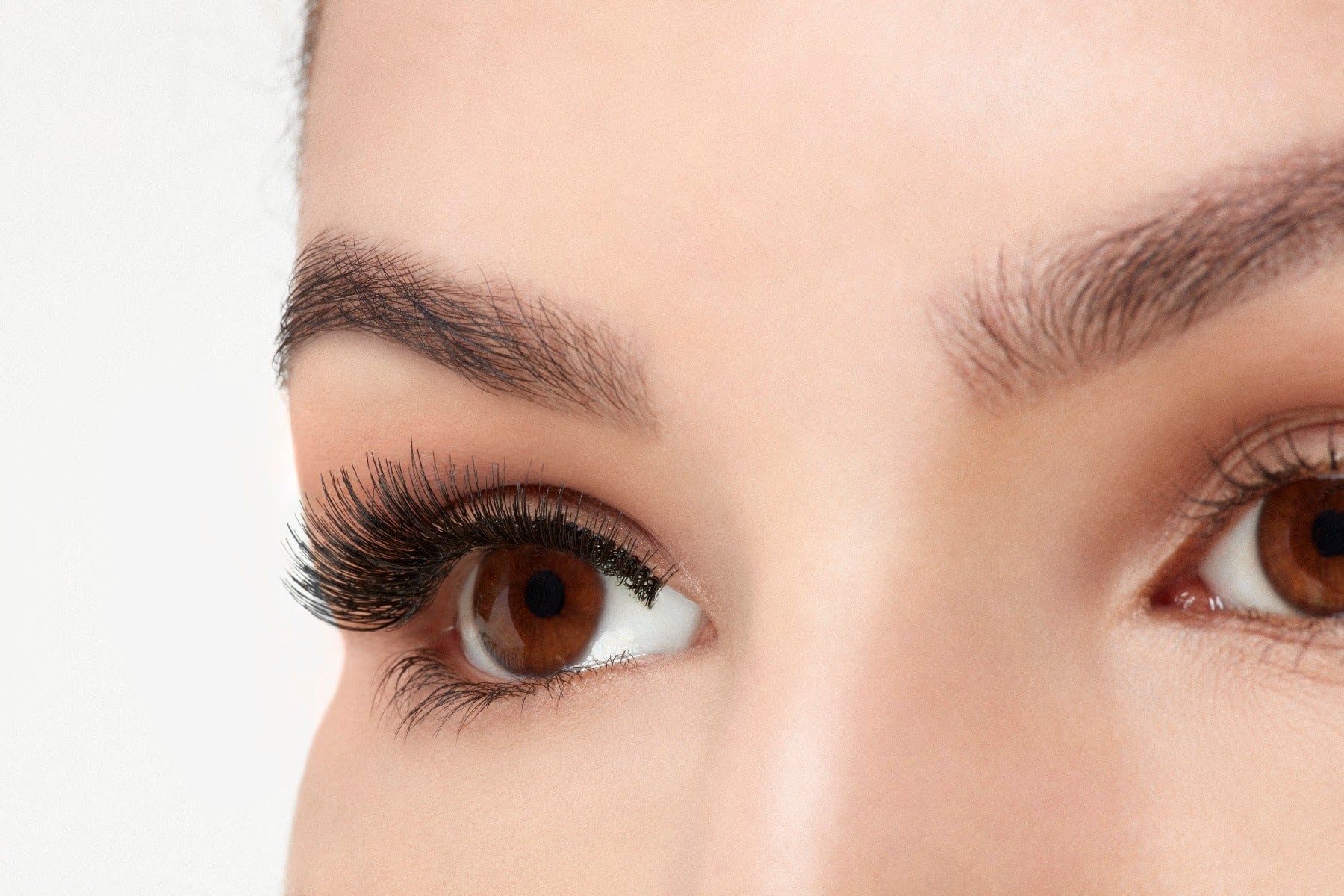 A model with an open right eye wearing Ardell Natural 105 showing how it looks like on an angled view