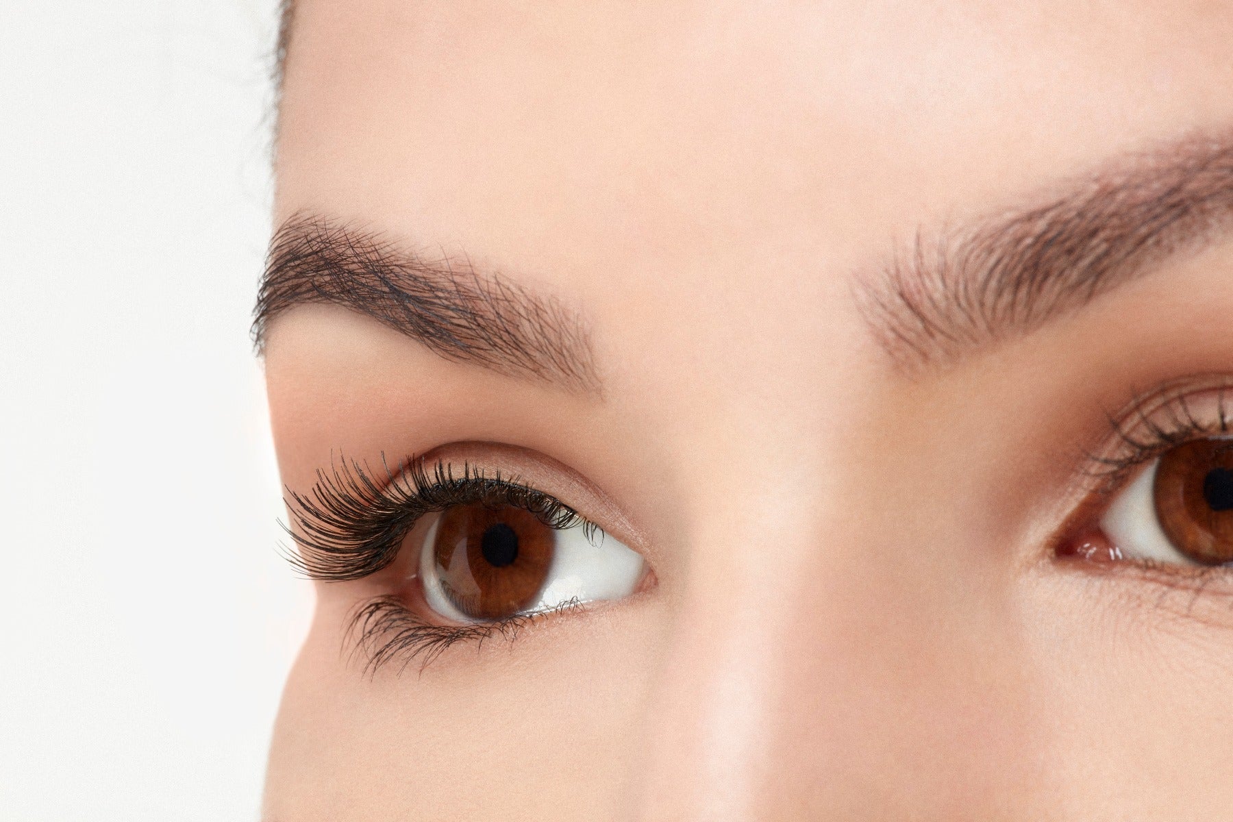 A model with an open right eye wearing Ardell Natural 110 showing how it looks like on an angled view