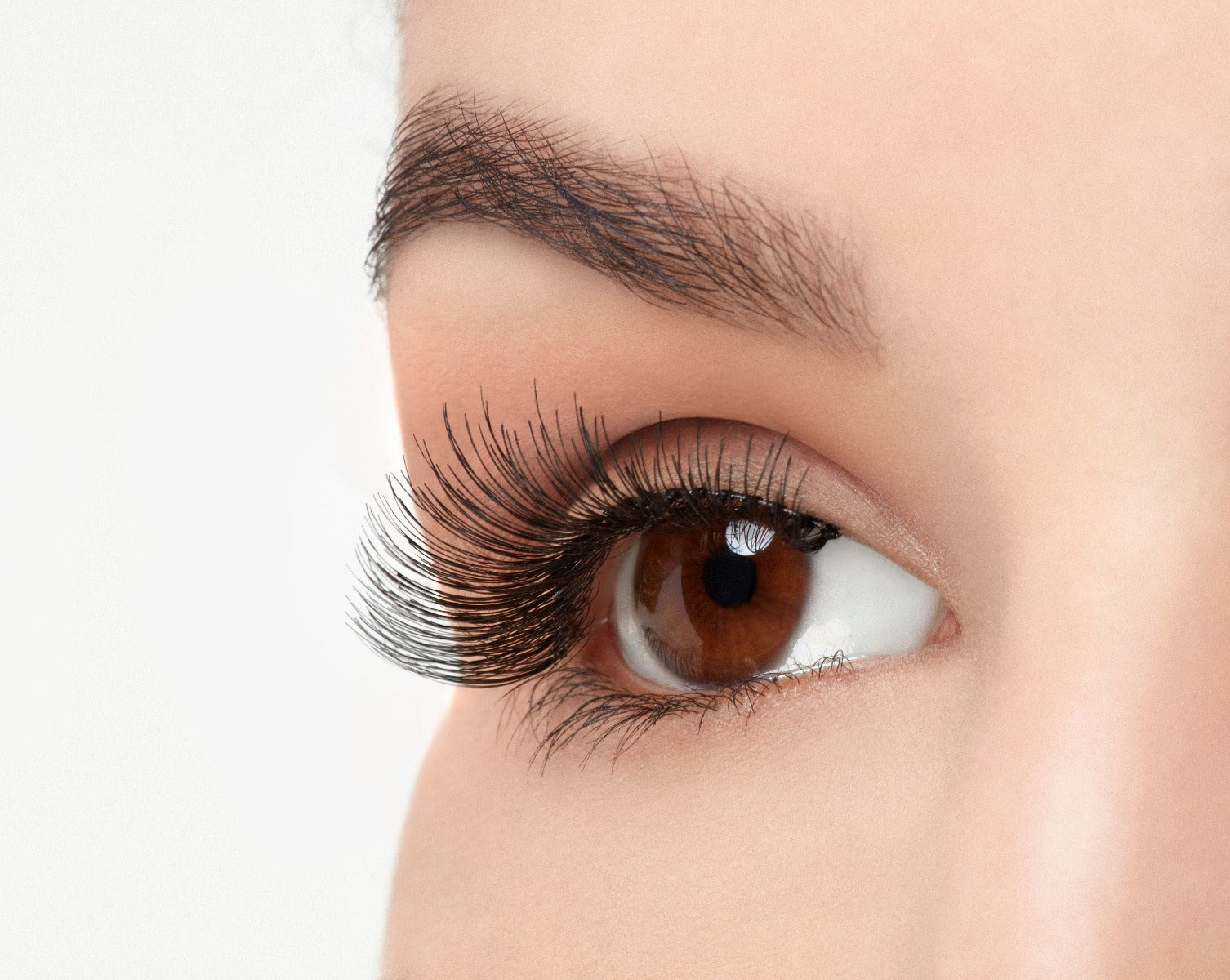 Angled close-up of a model's open right eye wearing an Ardell Natural 117 false lash