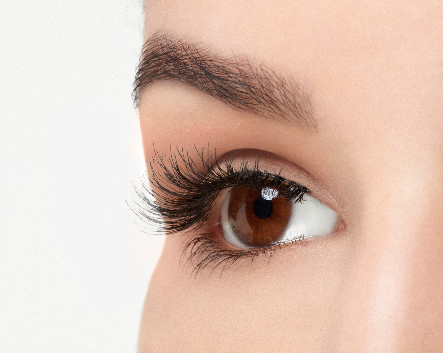A model with an open right eye wearing  Ardell Natural 120 showing how it looks like when worn in a side view