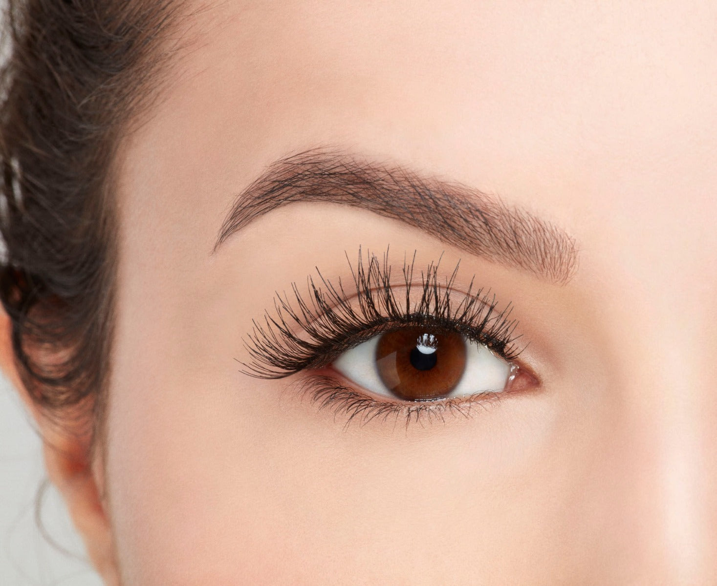 A model with an open eye wearing Ardell Studio EffectsWispies showing its flared, curly & natural lash look