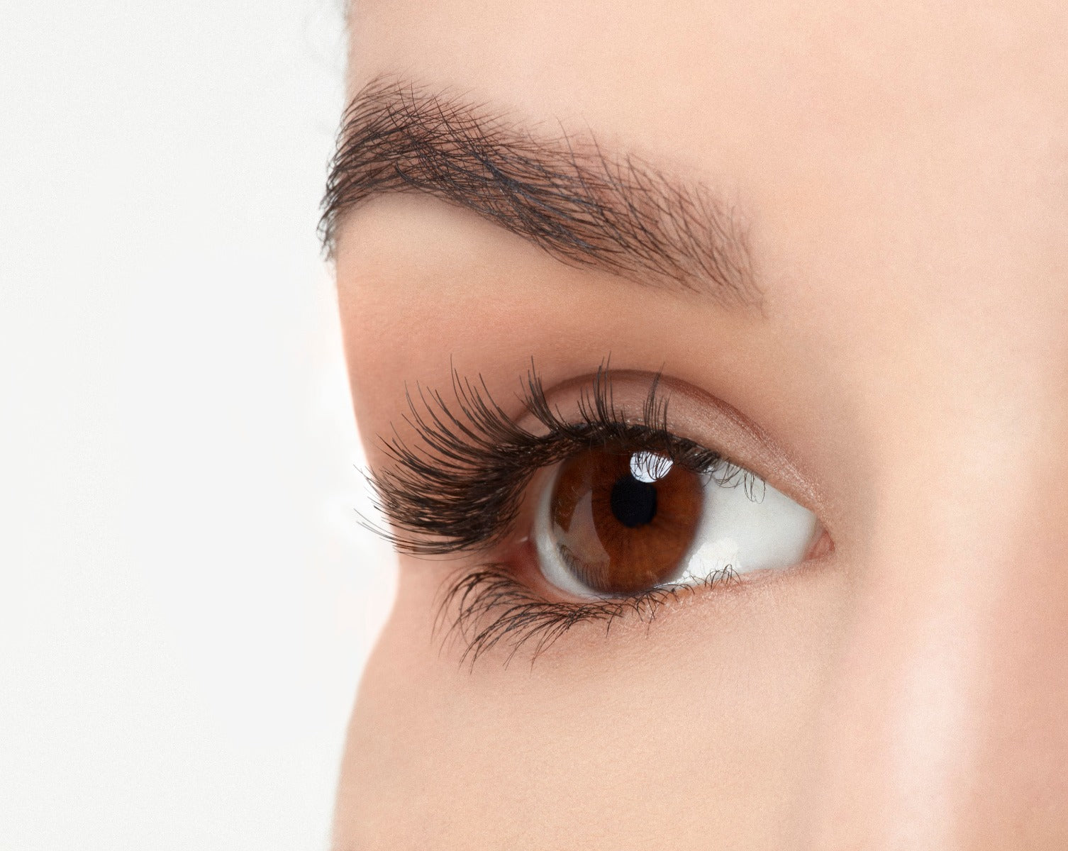 Angled close-up of a model's opened right eye wearing an Ardell Pre-cut Magnetic Lash 110 false lash