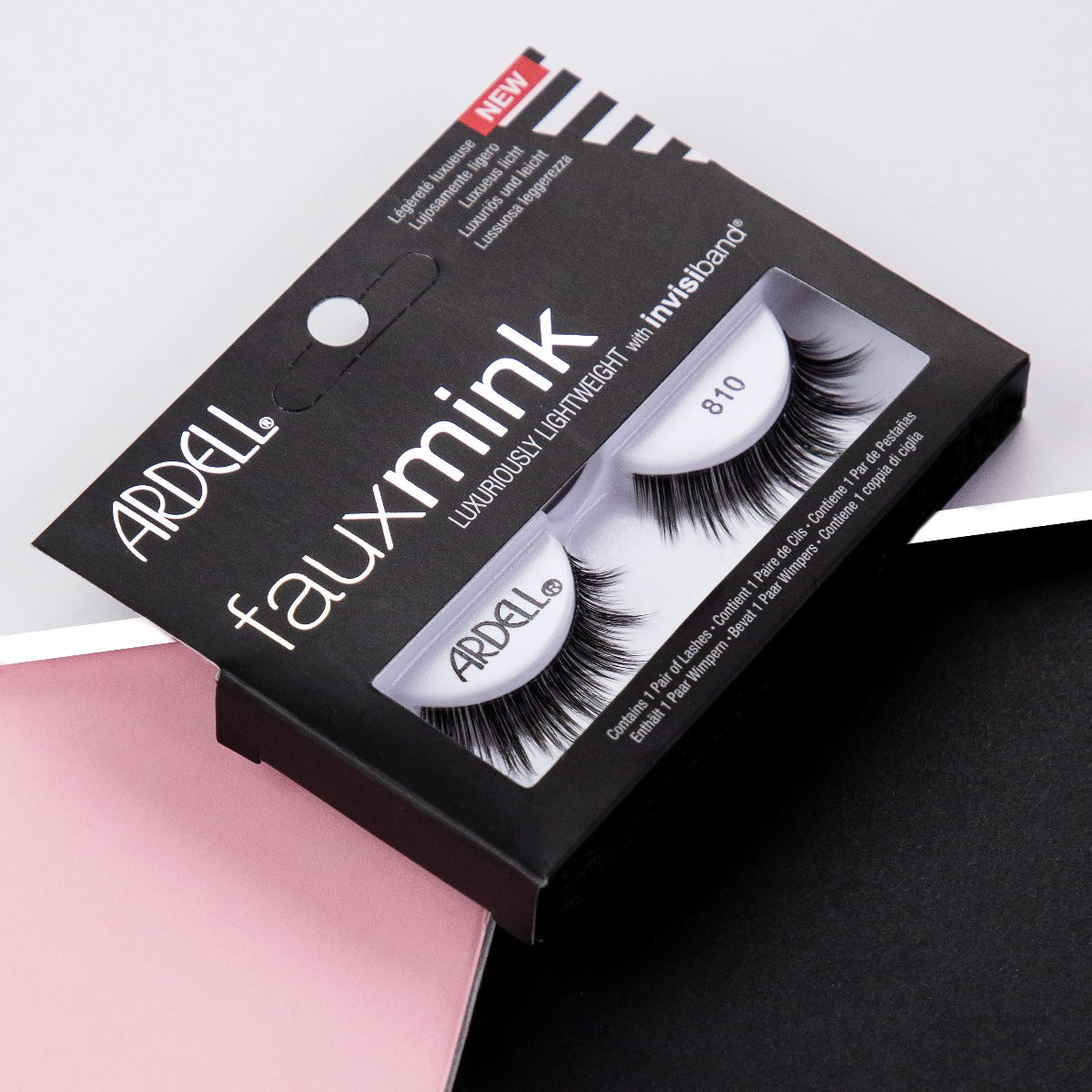 Ardell Faux Mink 810 retail box set against a stylized black, white, & pink background