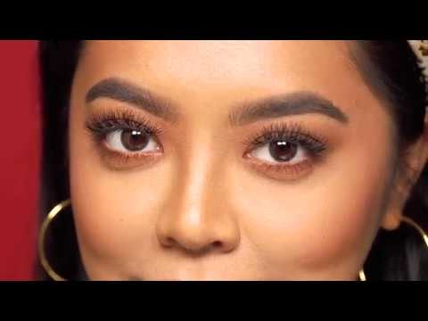 Woman with full, voluminous lashes wearing Ardell Beauty strip lashes.