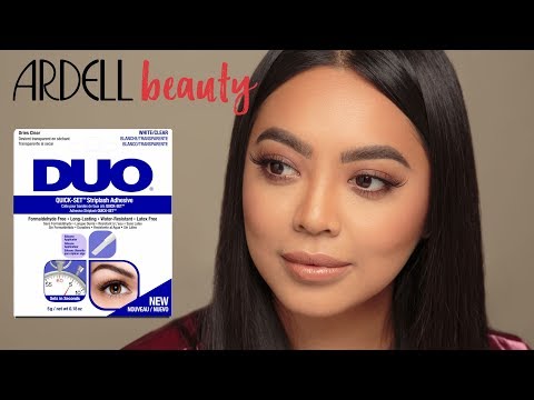 A model with flawless lashes using DUO Quick-Set Striplash Adhesive, featuring Ardell Beauty branding.