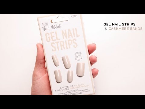 Hand holding Ardell Gel Nail Strips in Cashmere Sands, semi-cured for up to 14 days of wear.