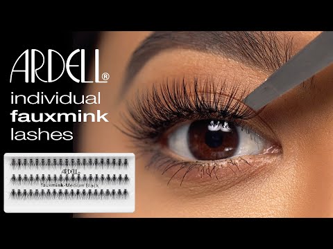 Ardell individual faux mink lashes being applied with tweezers for a soft, voluminous, and natural lash look.