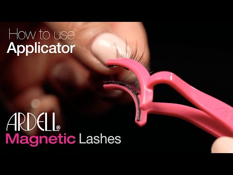 Close-up of Ardell Magnetic Lashes being applied using pink lash applicator tool.