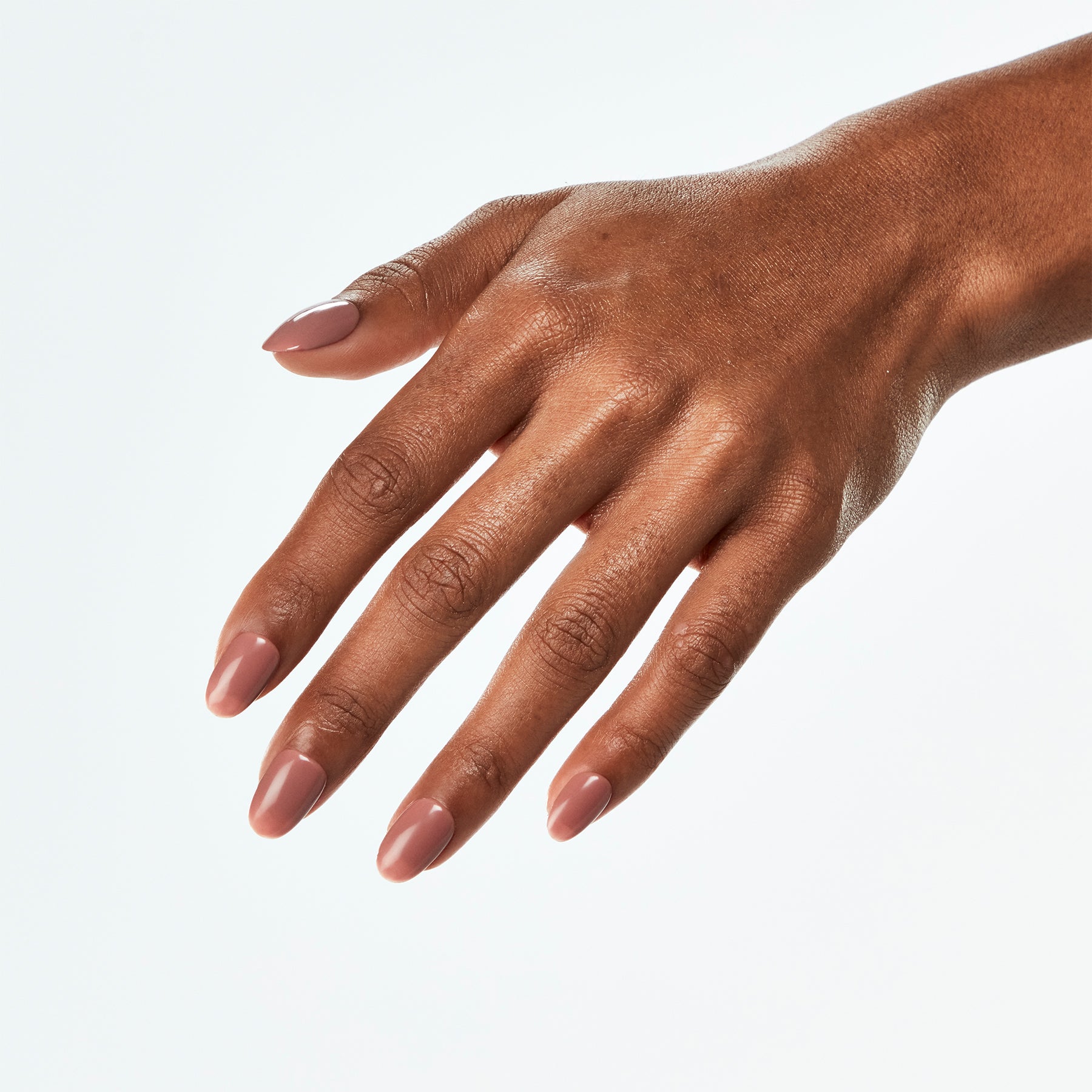 Hand with pink nail polish on a white background